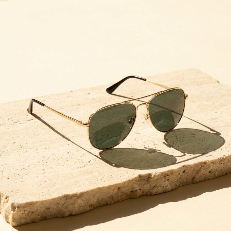 Gold metal aviator sunglasses with green-grey polarized lenses.